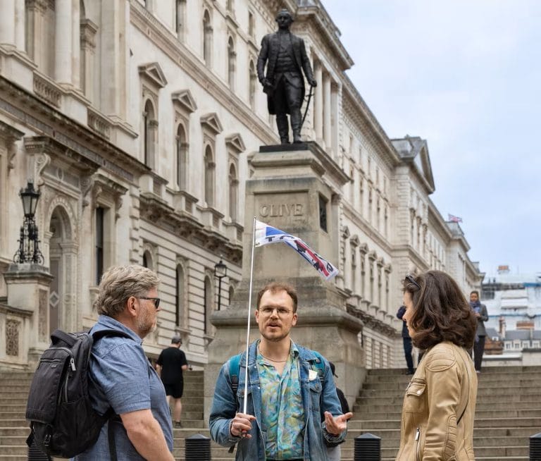 A guide talking to a small group beside the statue of Robert Clive at Clive Steps, near the Churchill War Rooms