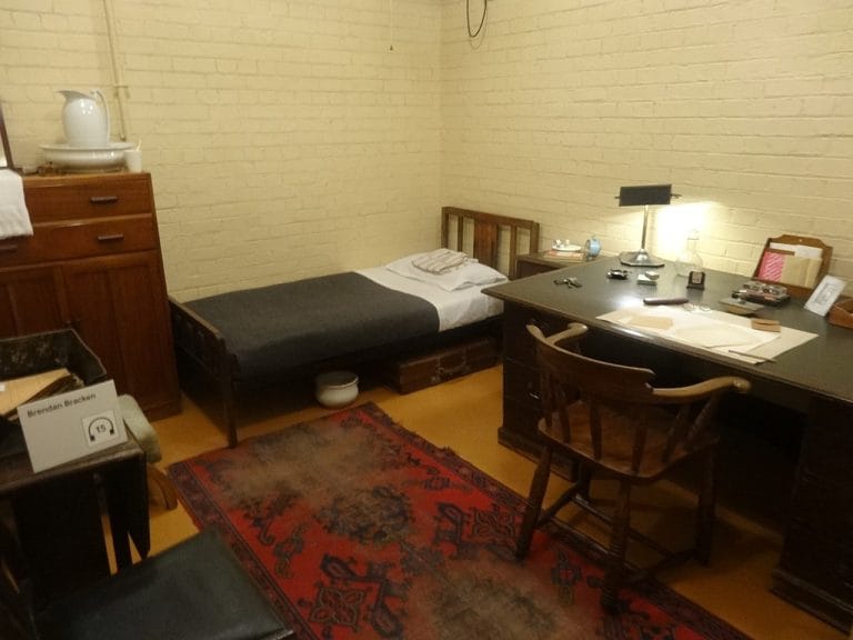 Churchill's bedroom in the Churchill War Rooms, with a single bed, a desk and a lamp