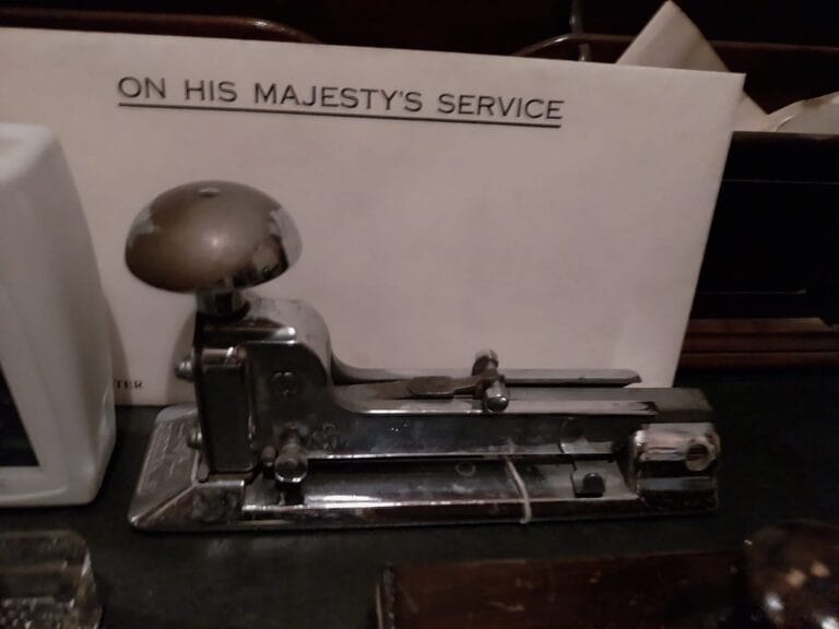 A desk in the Churchill War Rooms with a stapler and an envelope marked On His Majesty's Service