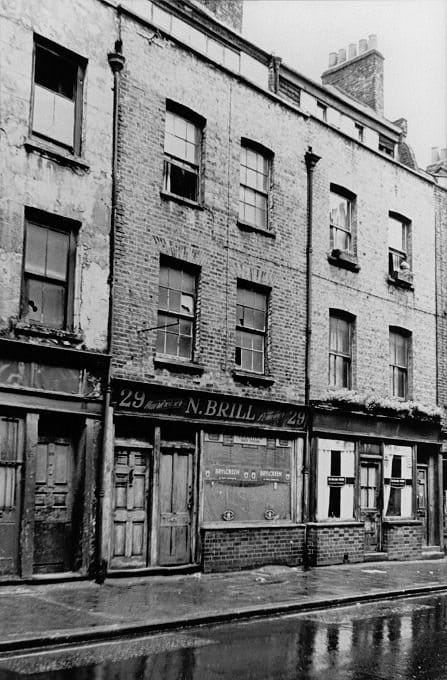 Old photograph of the three-storey terraced house at 29 Hanbury Street with a shop at street level