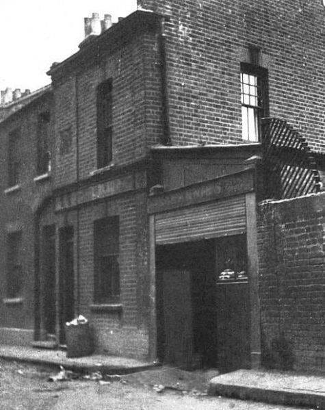 Old photograph of a brick building and stable yard gateway in Buck's Row, Whitechapel