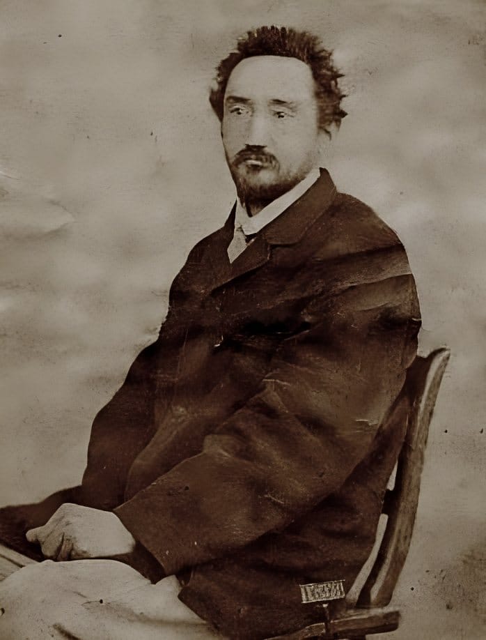 Photograph of Michael Ostrog seated, in a dark coat